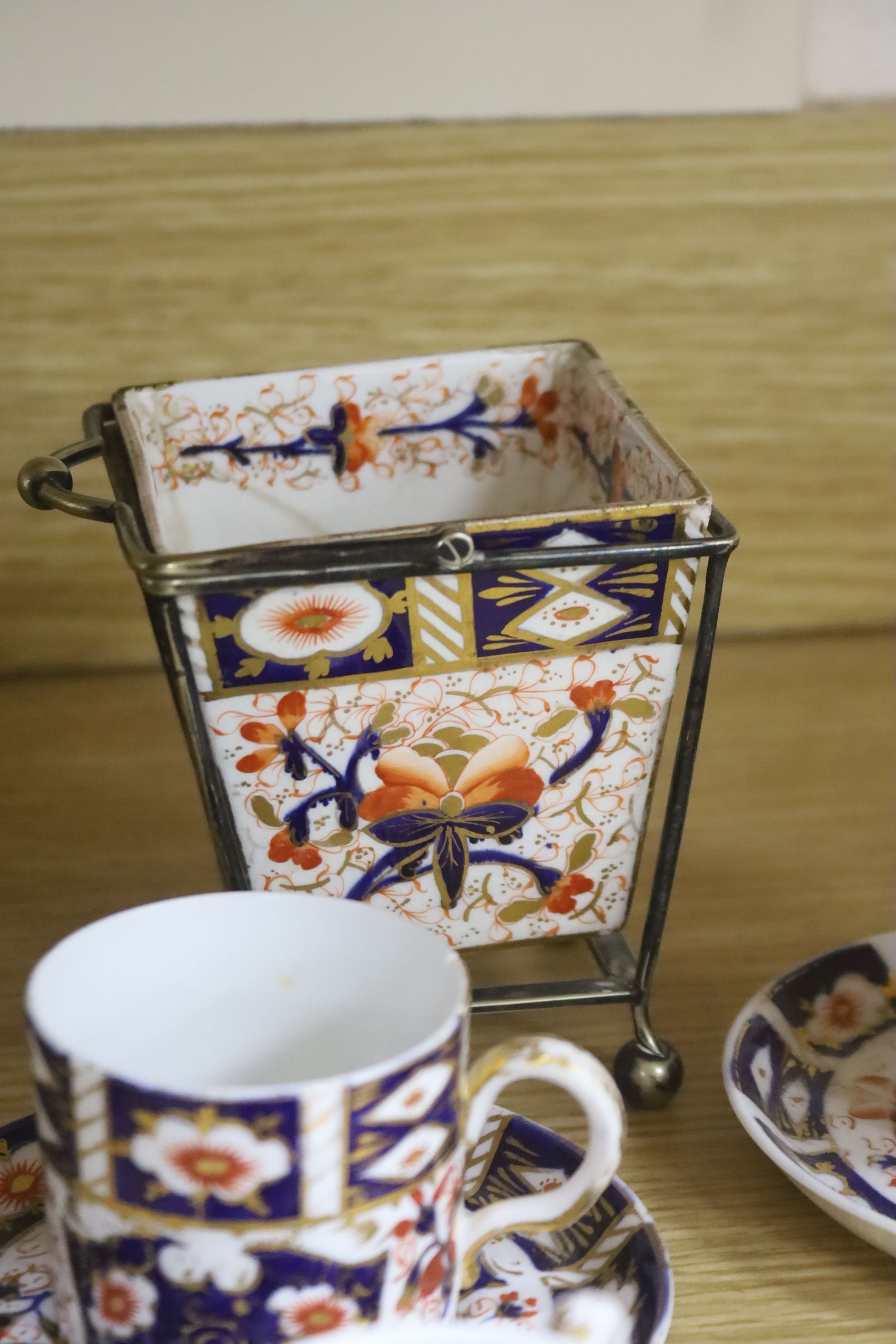 A collection of Royal Crown Derby Imari patterned ceramics including cups, side plates and platter